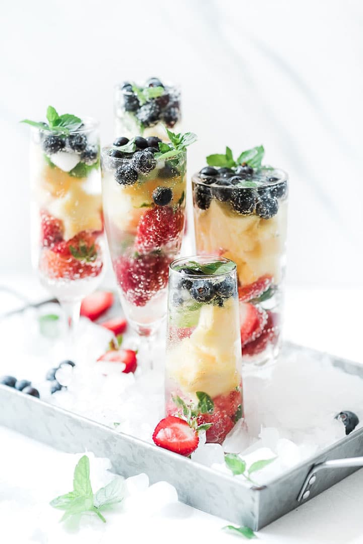 Red, white and blue spritzer setting on a tray of ice.