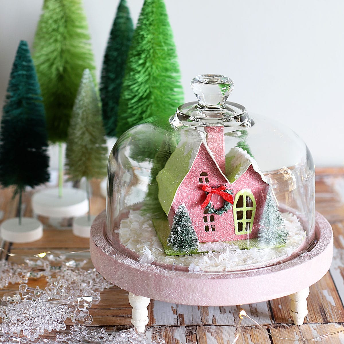 Thrift store cheese dome repurposed into cute snow covered Christmas scene.