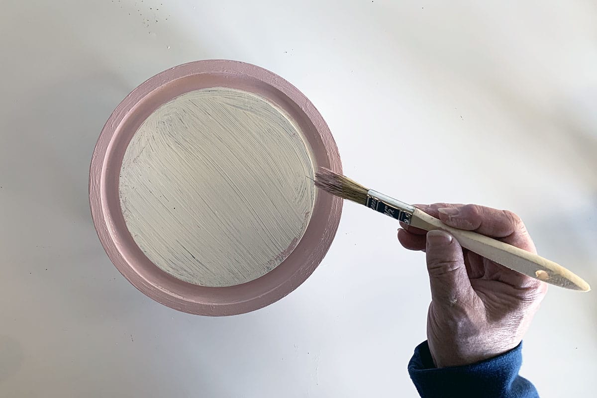 Painting the cheese dome base white and pink for Christmas decor.