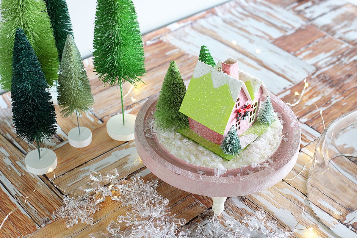 A snow scene inside a Christmas cloche.