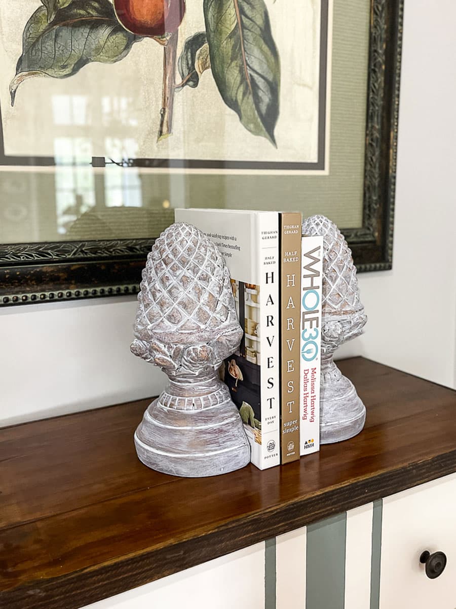 Thrift store bookends shaped like a pineapple are updated with a whitewash paint finish.