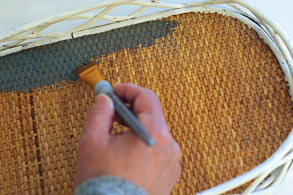 Painting the bottom of the thrift store tray with dark grey paint.