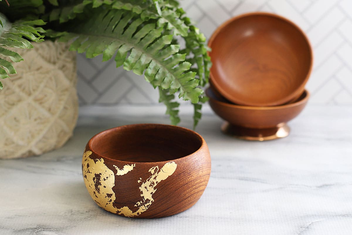 Wooden bowl that has been gold leafed to update it.