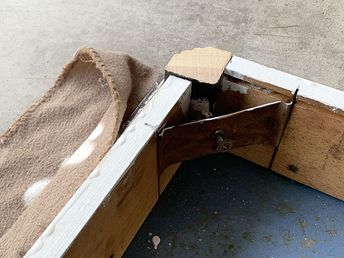 Screwing table legs into vintage kitchen table.