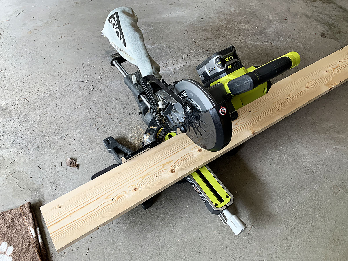 Usinf a miter saw to cut wood used to shore up the table top.