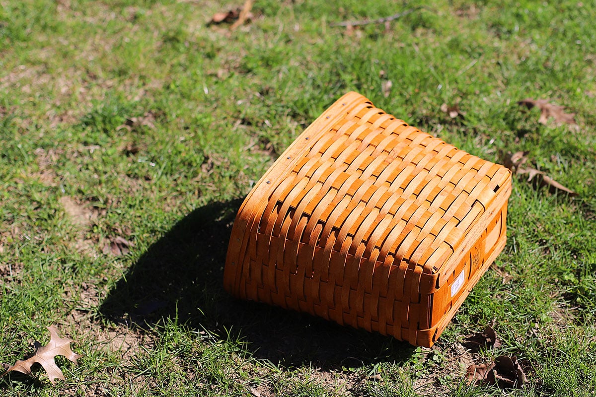 Drying a wooden Longaberger basket in the sun after being washed to remove stains and grease.