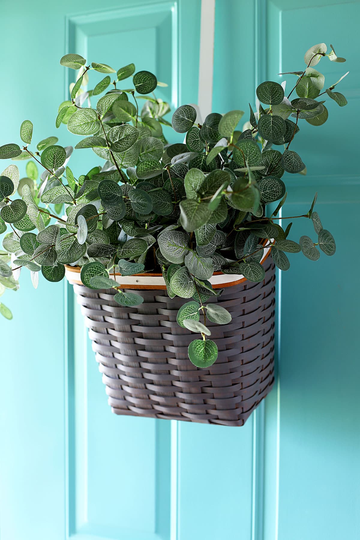 Vintage Longeberger basket that was painted and has been repurposed as a wreath for the front door.