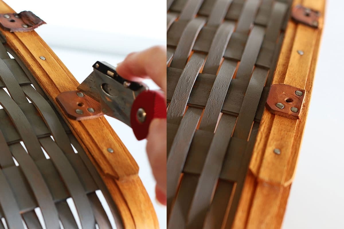 Using an x-acto knife to cut through the leather handles on the basket.