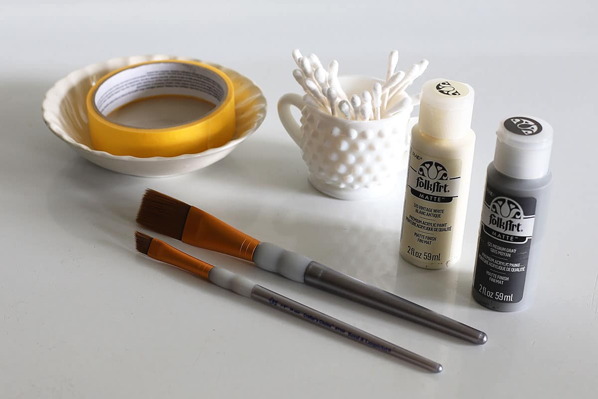 Supplies needed to paint Longaberger baskets - paintbrushes, paint, painters tape, moist q-tips and painters palette.
